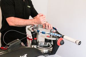 Peter Dalton stringing a racket on a stringing machine