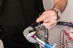 Peter Dalton stringing a racket on a stringing machine