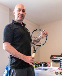 Peter Dalton standing with a tennis racket