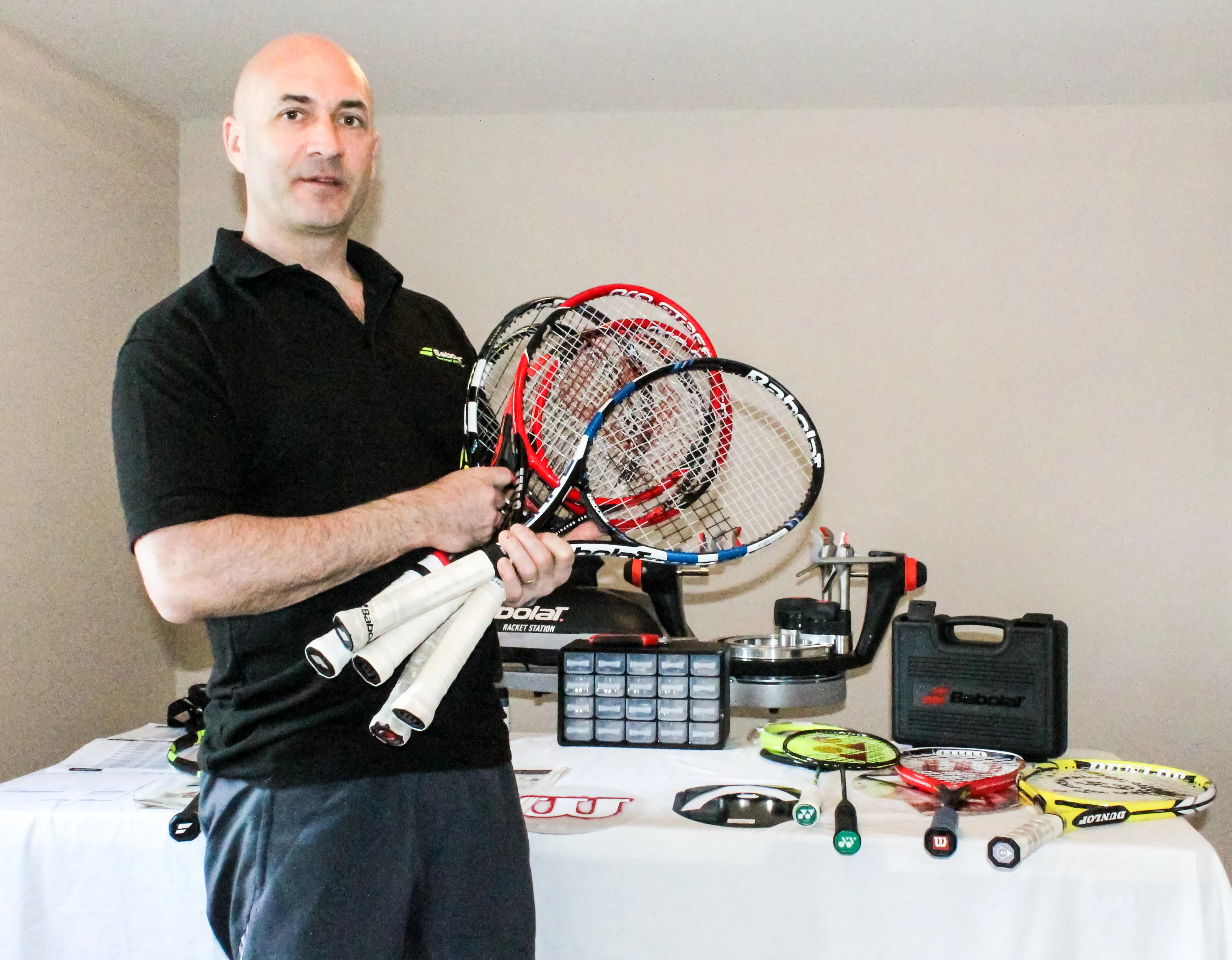 Peter Dalton holding recently strung tennis rackets